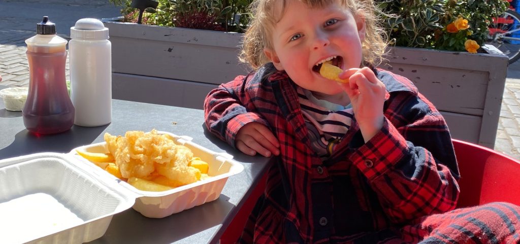 A kids meal at Cromar's chippy in St Andrews being enjoyed by a little girl