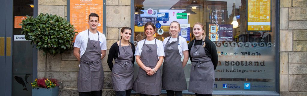 Staff members outside the fish and chip shop