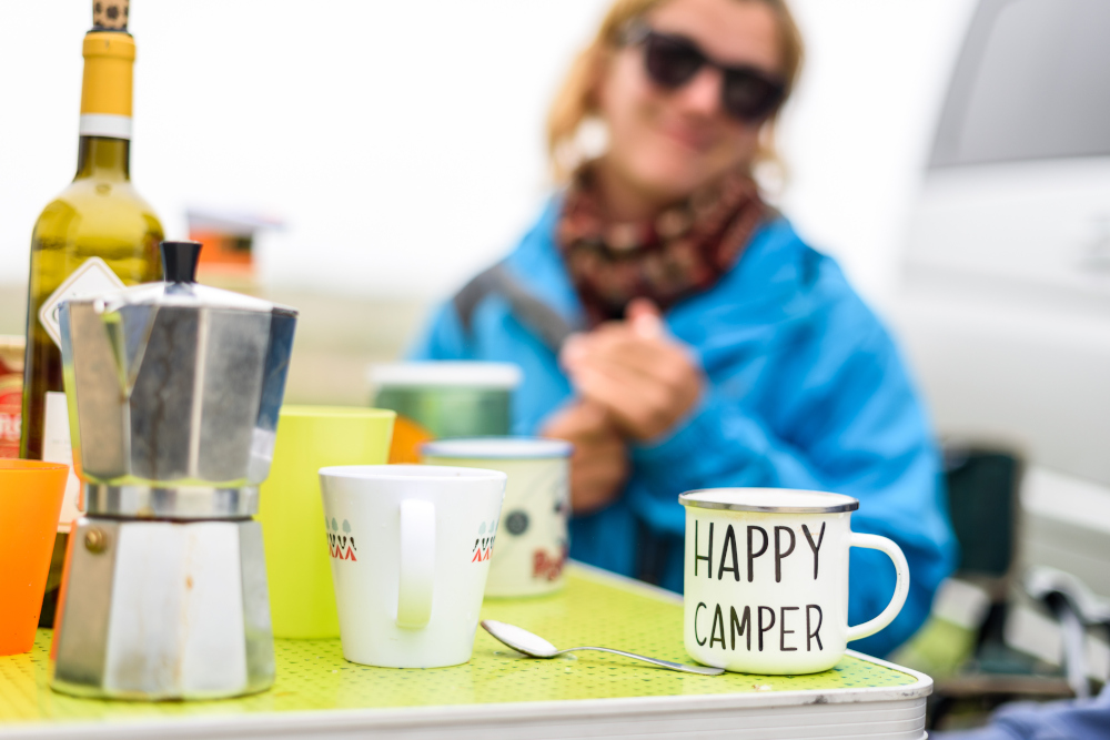 Woman on holiday with a Happy Camper mug