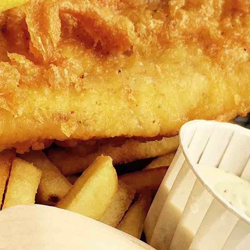 A fish and chips served on a newspaper